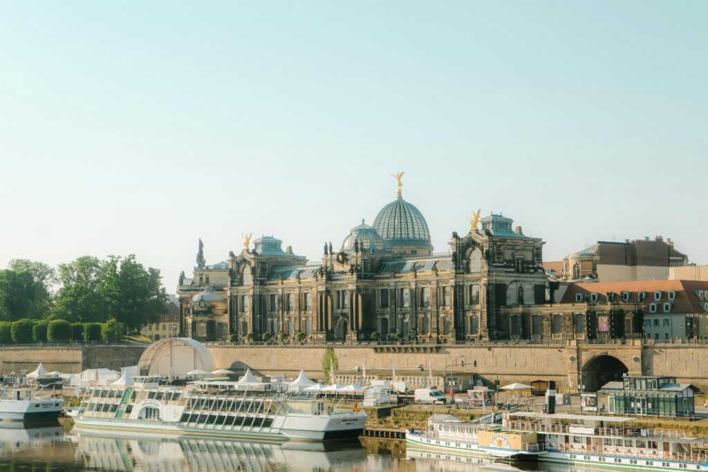 pexels photo 17209226 17209226 View of the Academy of Fine Arts Dresden with boats on the Elbe River under a clear sky.