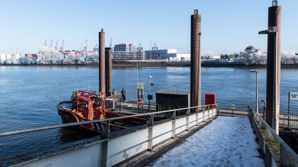 pexels photo 30331627 30331627 A serene winter view of Hamburg port with a frost-covered jetty and a moored boat.