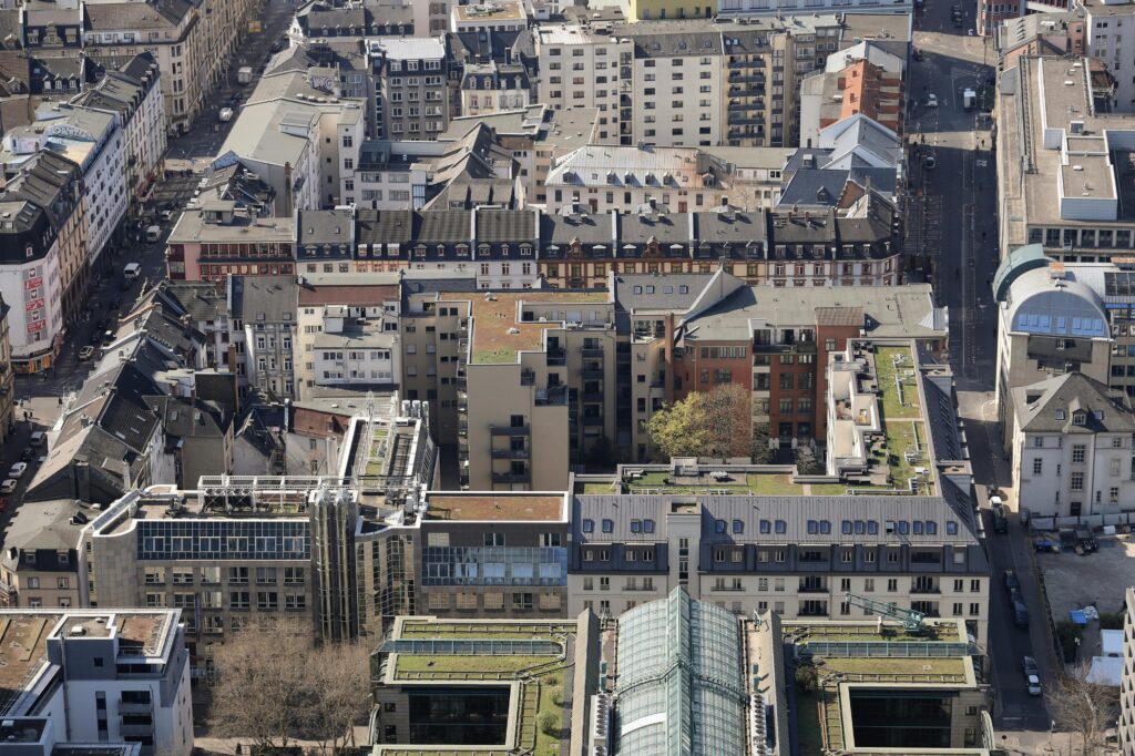 Aerial view showcasing the urban residential neighborhood in Frankfurt am Main, featuring mixed architecture and green rooftops.