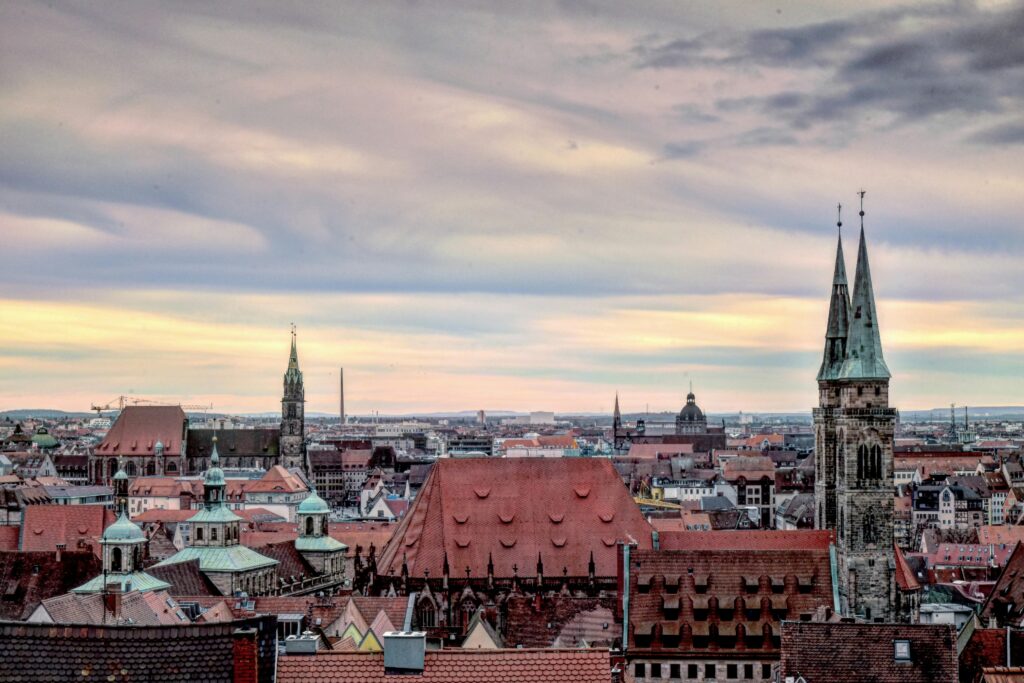 pexels photo 8405817 8405817 A stunning view of Nuremberg's historic skyline with iconic church towers and a vibrant sky.
